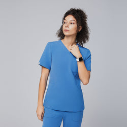 Image of Woman wearing a sky-blue V-neck scrub top with short sleeves and matching pants, looking confidently to the side while showcasing the sleek and professional design of the uniform,Sky Blue