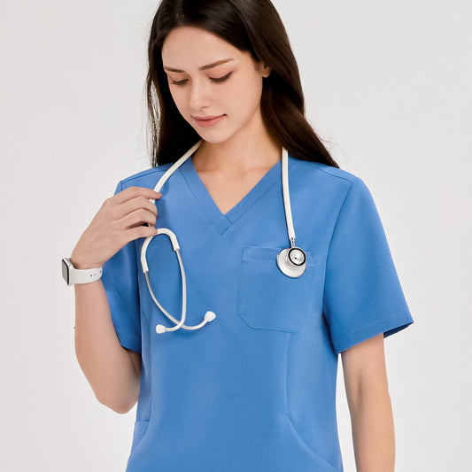 Woman wearing a V-neck scrub top with a stethoscope around her neck, looking down. A smartwatch is visible on her wrist,Sky Blue