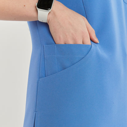 Close-up of a woman's hand in the side pocket of a scrub top, with a smartwatch visible on her wrist,Sky Blue