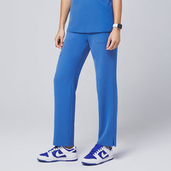 Image of Model wearing the sky blue scrub pants, showing a straight-leg design and functional pockets, paired with matching blue-and-white sneakers,Sky Blue