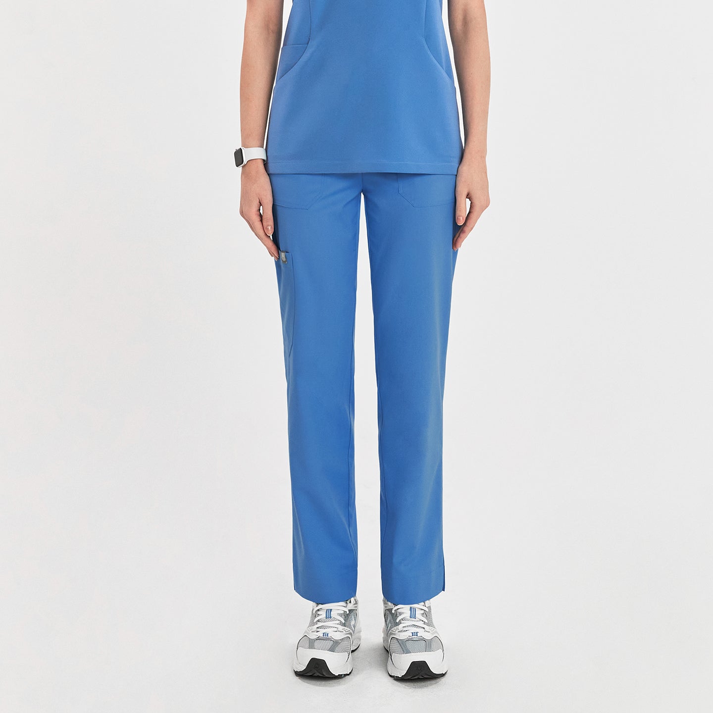 Woman in sky blue zipper slit scrub pants with a front pocket, shown from the front, paired with a matching scrub top,Sky Blue