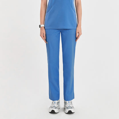 Woman in sky blue zipper slit scrub pants with a front pocket, shown from the front, paired with a matching scrub top,Sky Blue