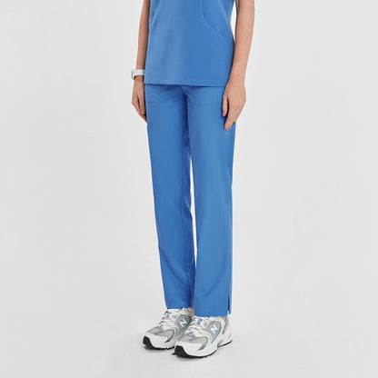 Woman in sky blue zipper slit scrub pants with a side pocket, shown from the front with a matching scrub top,Sky Blue