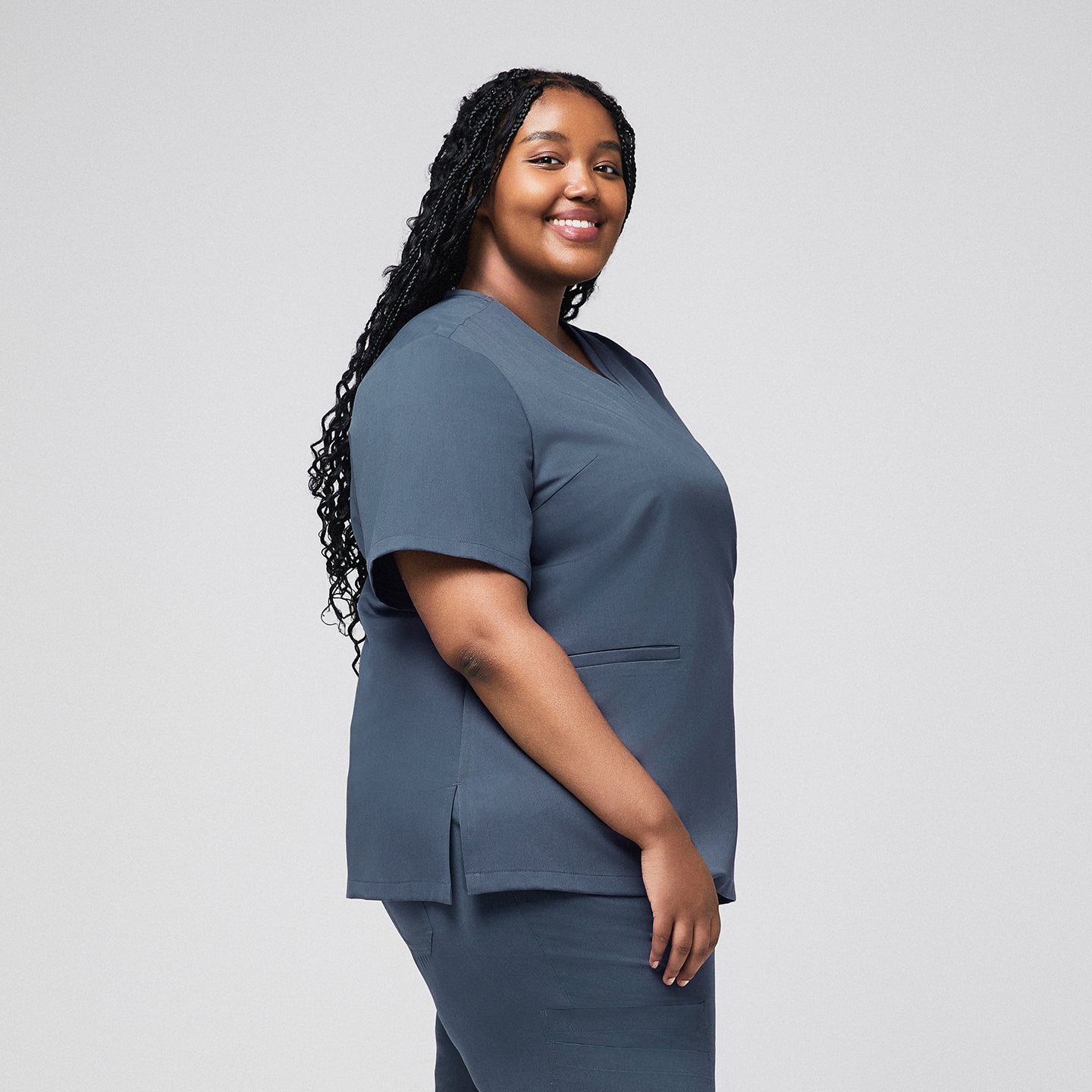 Plus-size healthcare professional in smoky blue scrub top with side view and double pockets,Smoky Blue