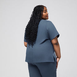 Image of Plus-size healthcare professional in smoky blue scrub top, showing the back view with long curly hair cascading down,Smoky Blue