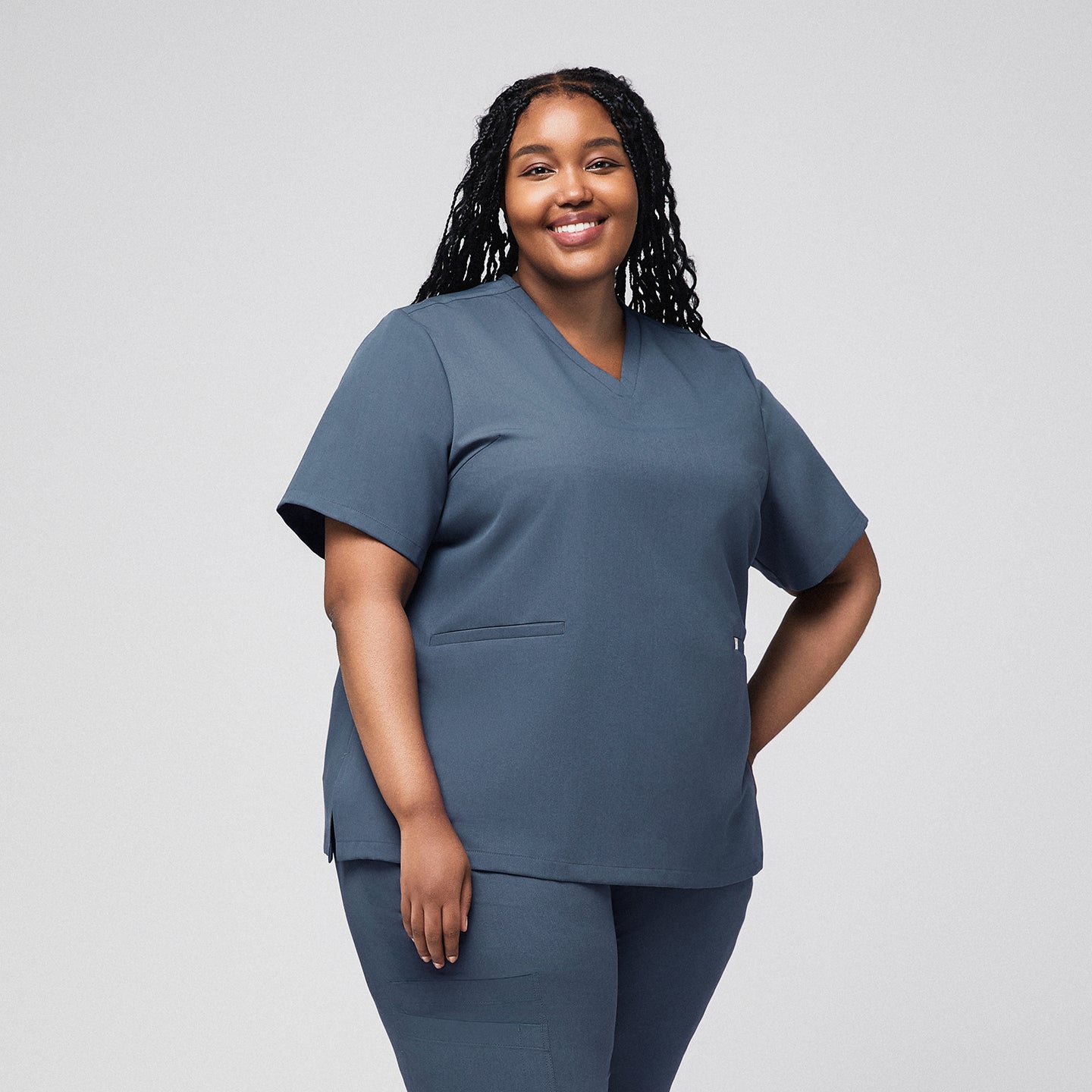 Plus-size healthcare professional in smoky blue scrub top with double front pockets,Smoky Blue