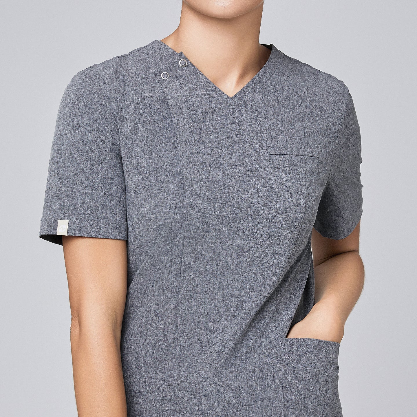 Close-up of Zenir soft gray front zipper scrub top, highlighting the zipper detail and chest pocket,Ash Gray