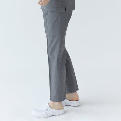 A woman showcasing the side view of Soft Gray Line Banding Scrub Pants, paired with white shoes, highlighting the fit and detail of the pants,Soft Gray
