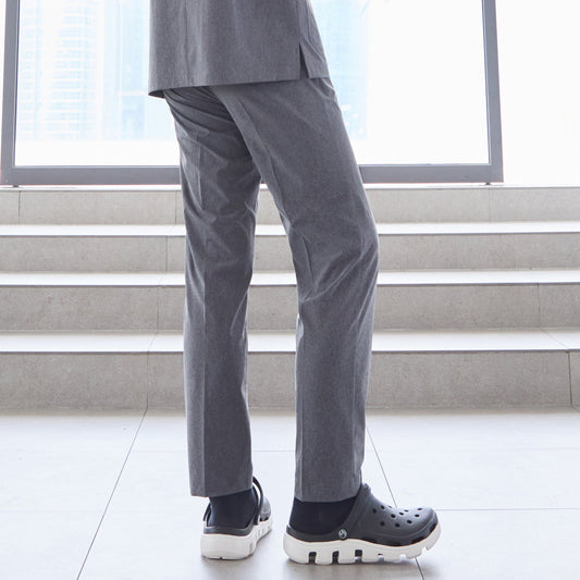 Close-up of man wearing straight-leg scrub pants, standing on stairs indoors,Soft Gray