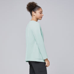 Image of Side profile of a woman wearing a soft mint comfort cardigan paired with black scrub pants, highlighting the cardigan's clean and professional design,Soft Mint