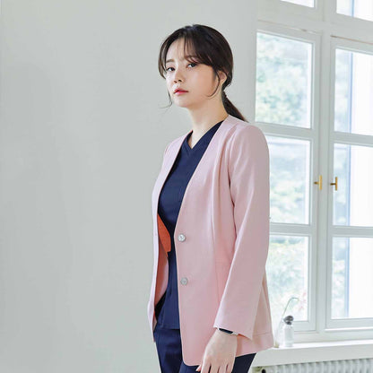 Woman in soft pink Zenir jacket over navy top, standing and looking at the camera, side view, with a window in the background,Soft Pink