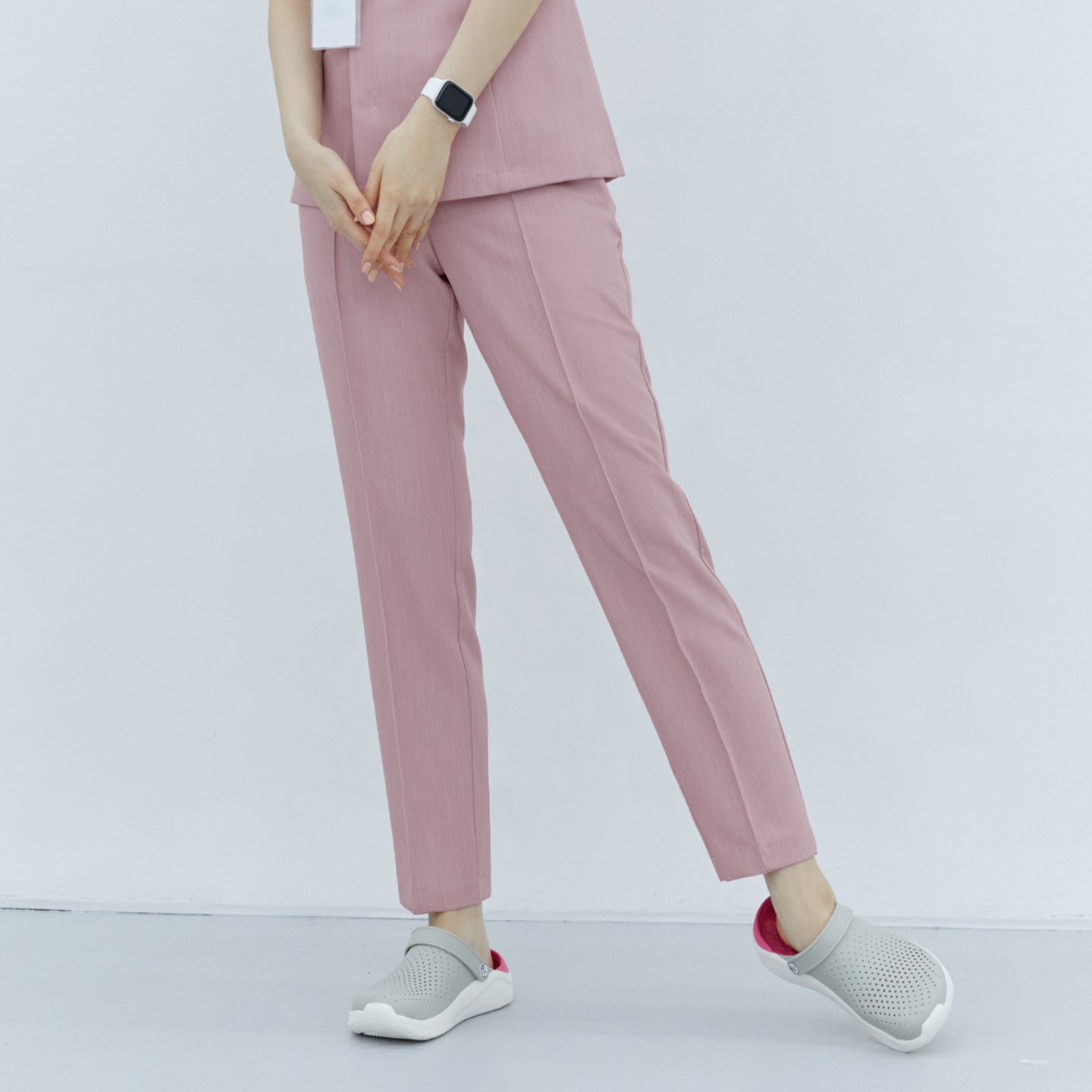 Soft Pink Line Banding Scrub Pants, half-side view, highlighting the clean lines and comfortable fit, paired with gray shoes,Soft Pink