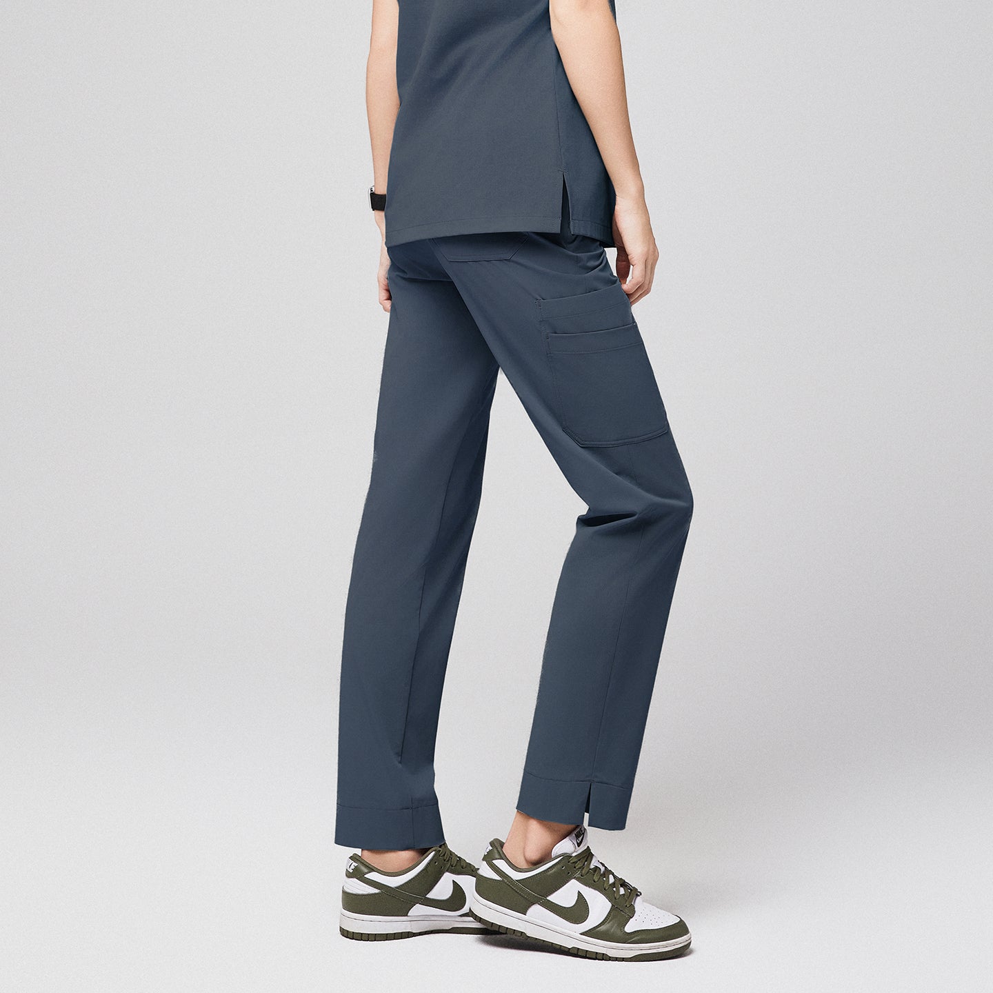 Smoky blue scrub pants with split hem and side pocket, paired with green and white sneakers,Smoky Blue