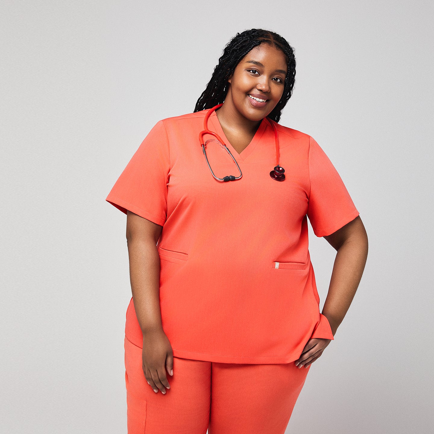 Plus-size healthcare professional in Tiger orange scrub top with stethoscope,Tiger Orange