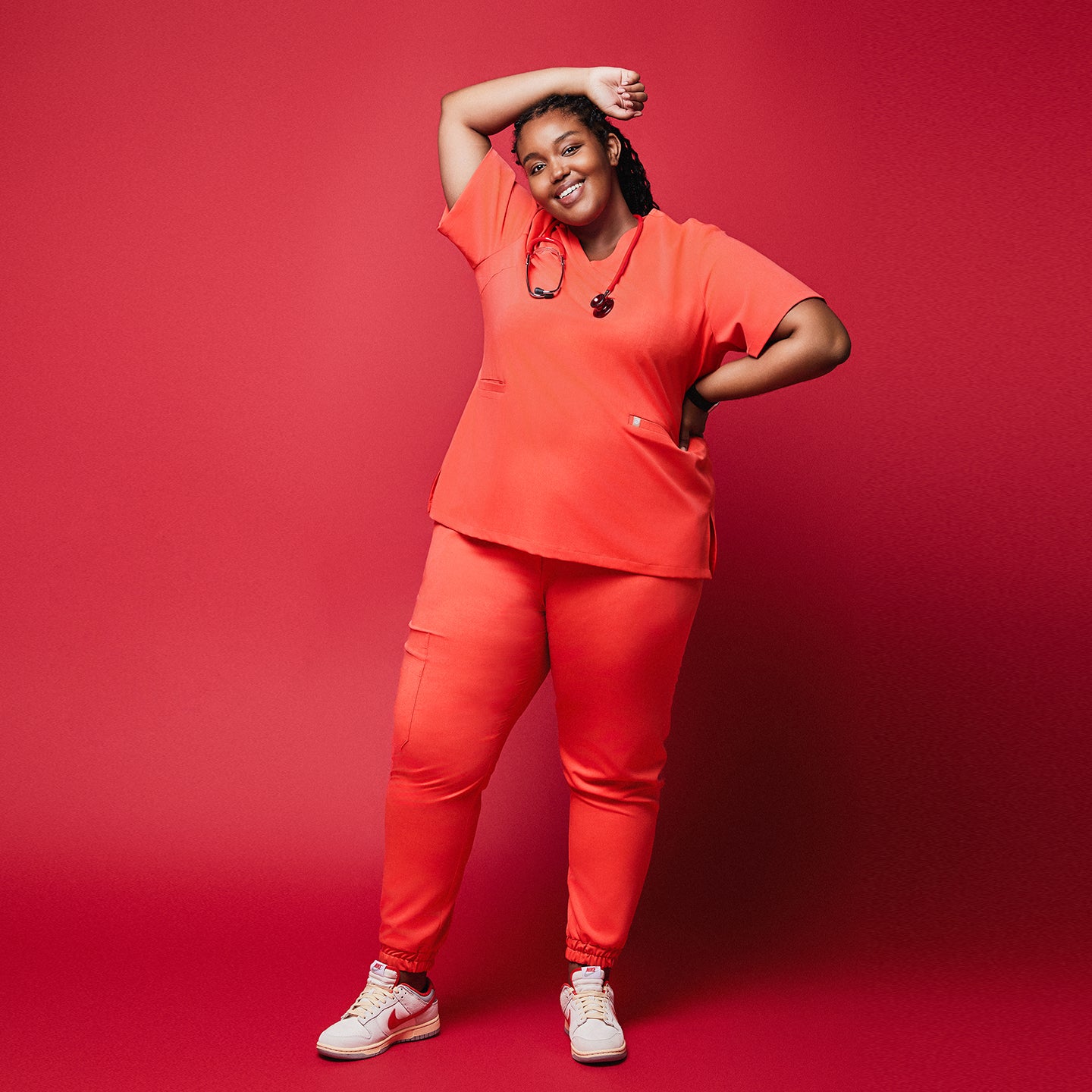 Plus-size healthcare worker in Tiger orange scrub set with stethoscope and jogger pants,Tiger Orange