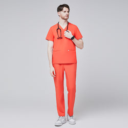 Image of Man wearing tiger orange scrubs with a V-neck and double pockets, holding a black stethoscope, paired with white sneakers,Tiger Orange