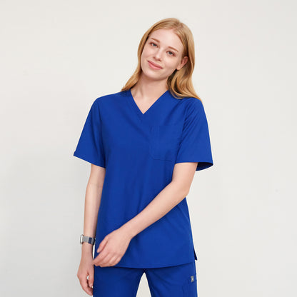 Blonde woman smiling, wearing a V-neck scrub top with a chest pocket, and matching pants, Royal Blue