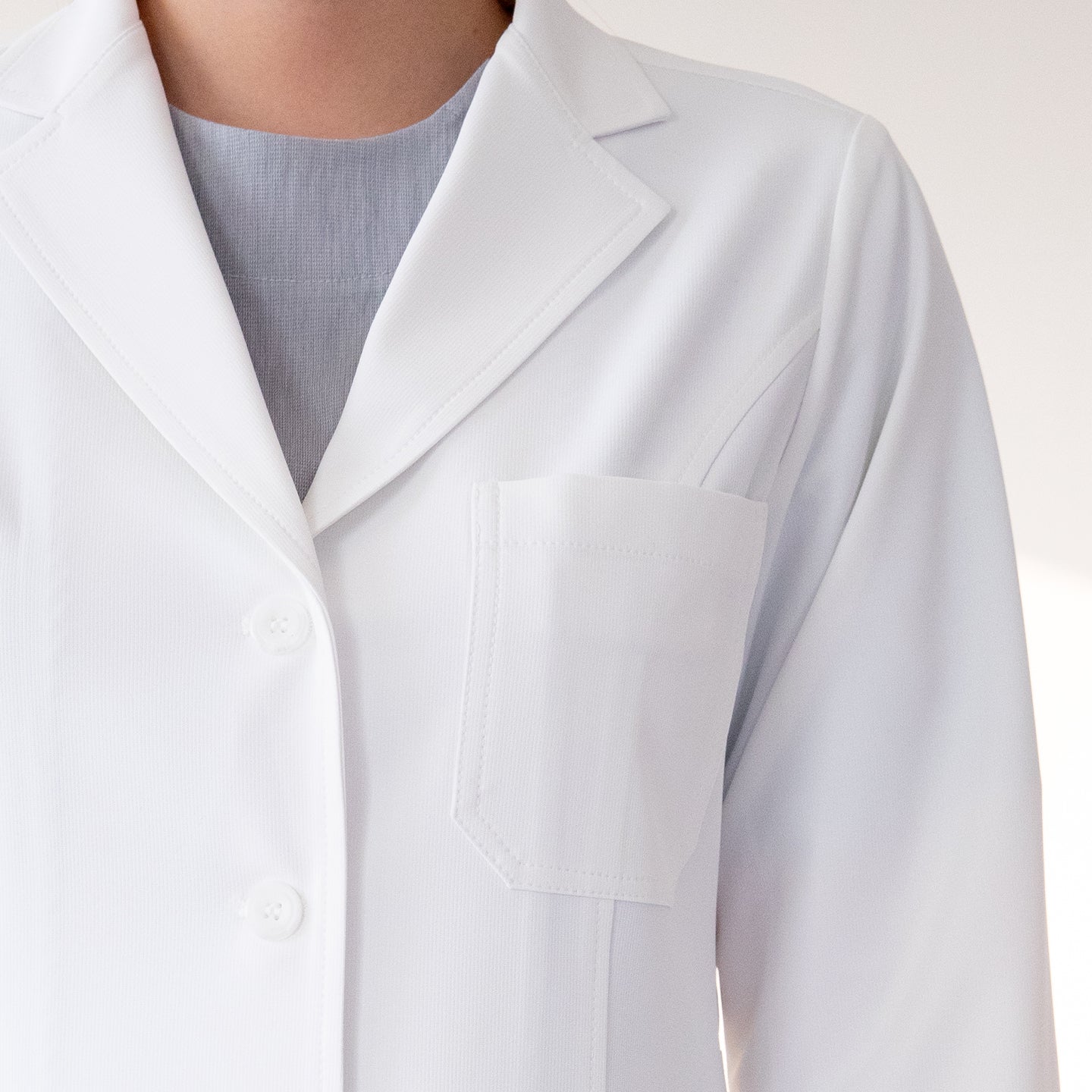 Close-up of chest pocket and buttons on Zenir White Long Lab Coat LCW-04,White