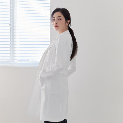 Woman in Zenir White Long Lab Coat LCW-04, side view with hands in pockets, belted back detail,White