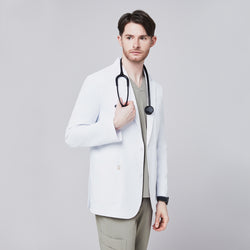 Image of Front view of a male model wearing a white short lab coat over olive green scrub pants, showcasing clean and tailored design,White