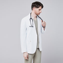 Image of Front view of a male model wearing a white short lab coat over olive green scrub pants, showcasing clean and tailored design,White