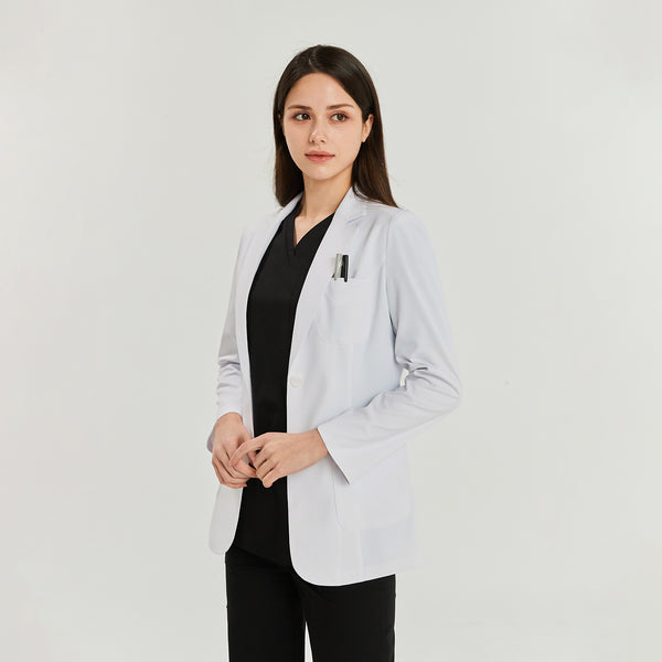 White lab coat with one chest pocket and two front pockets, worn over a black scrub top and pants. The model is facing forward,White